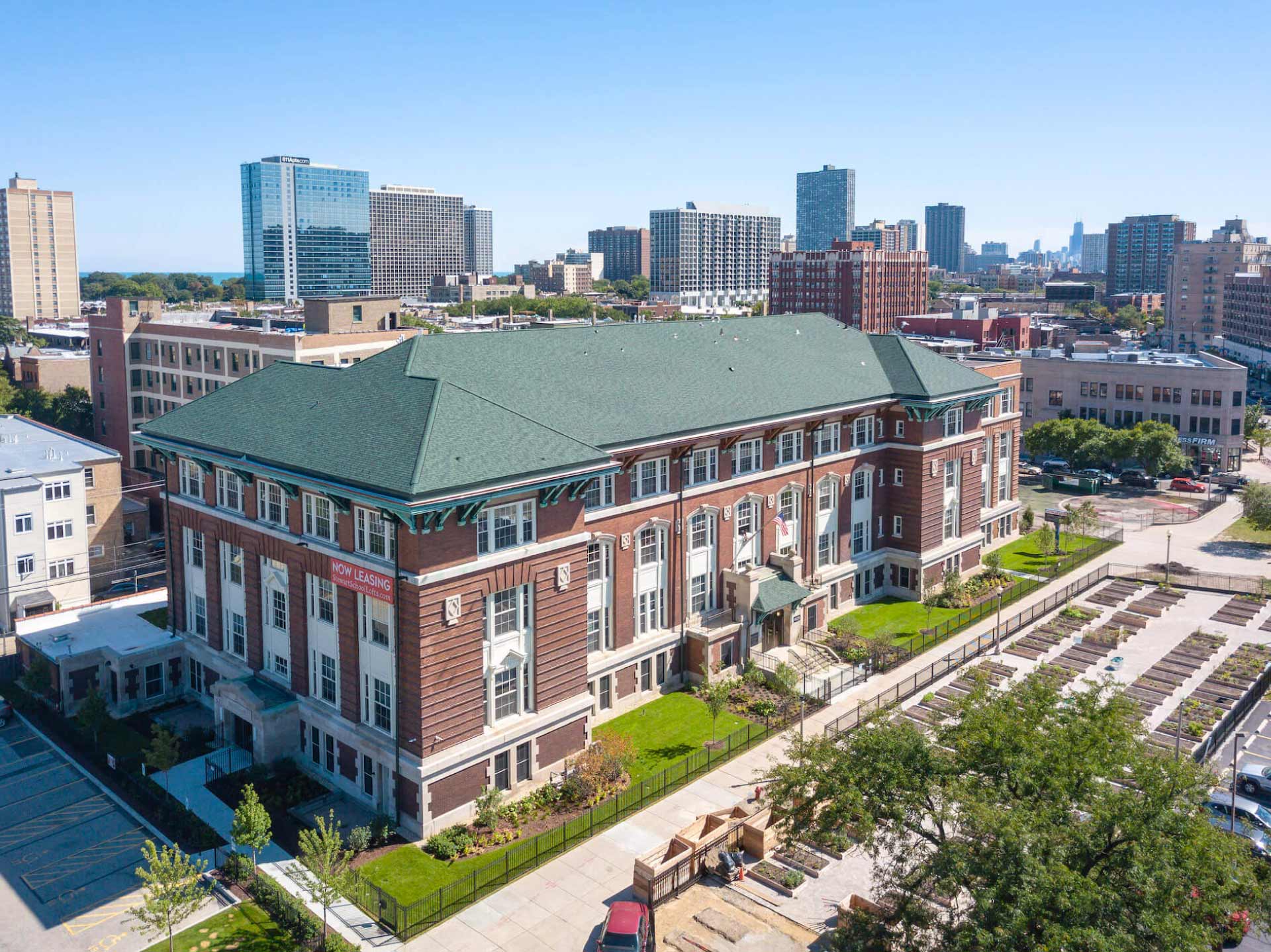 Exterior, aerial view of Stewart School Lofts building and surrounding urban area.